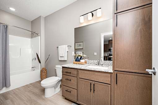A bathroom with a toilet, sink, and shower.