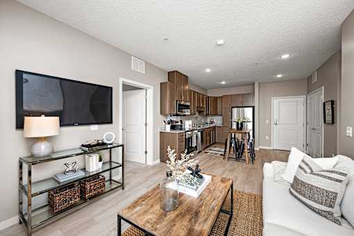 A modern living room with a flat screen TV mounted on the wall.