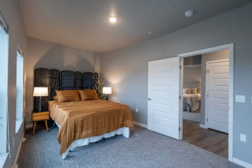 a bedroom with a bed and a door to a bathroom at Technology Park Apartments, Minnesota
