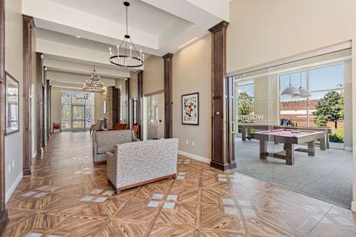 the estates at tangle wood living room with pool table at The Winslow 62+ Apartments, West St Paul, MN
