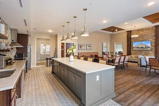 a large kitchen with a center island and a dining room at The Winslow 62+ Apartments, West St Paul