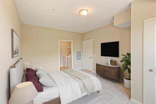 a bedroom with a bed and a dresser and a tv at The Winslow 62+ Apartments, West St Paul, MN