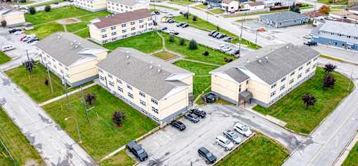 A large building complex with a parking lot in front.