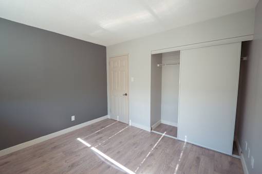 A room with a wooden floor and a white door.