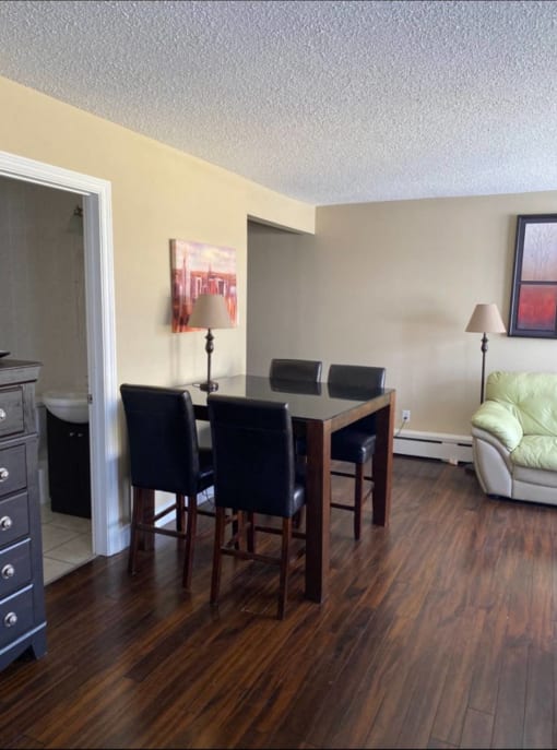 a dining room and living room with a table and chairs