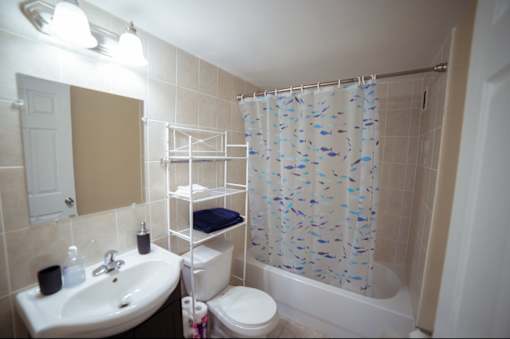 A bathroom with a sink, toilet, and shower.