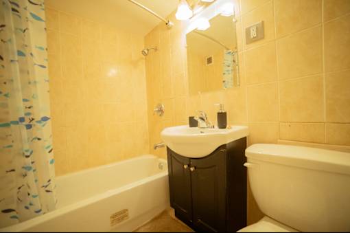 A bathroom with a white sink and a white bathtub.