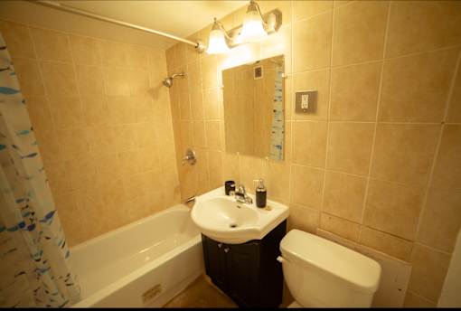 A bathroom with a white sink and a white toilet.