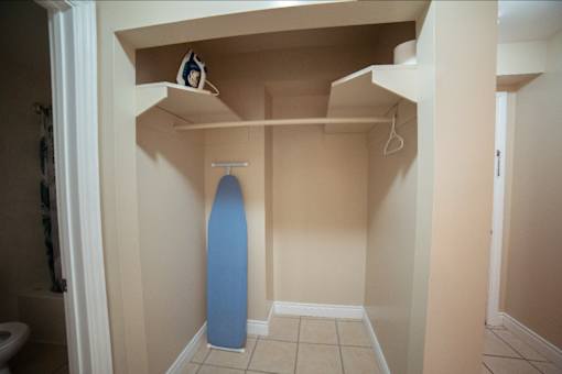 A blue surfboard is leaning against the wall in a small room.