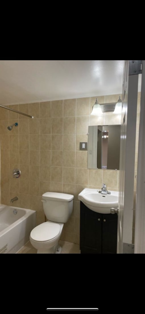 a bathroom with a toilet sink and a shower