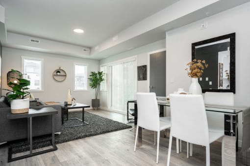 a dining room and living room with a table and chairs