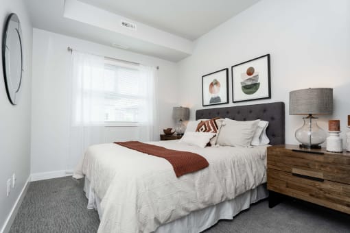a bedroom with a large bed and a large window