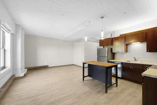 A kitchen with wooden cabinets and a table.