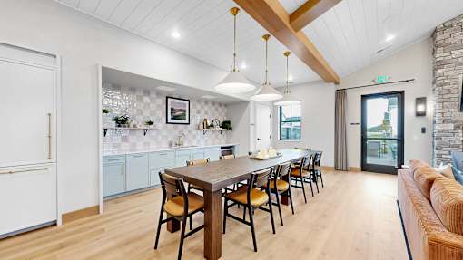 A modern kitchen with a dining table and chairs.