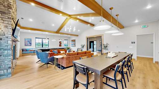 A dining room with a long table and chairs.