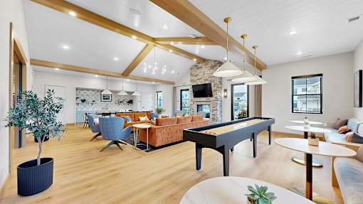 A living room with a pool table and a television.