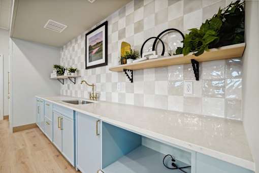 A kitchen with blue cabinets and a white countertop.