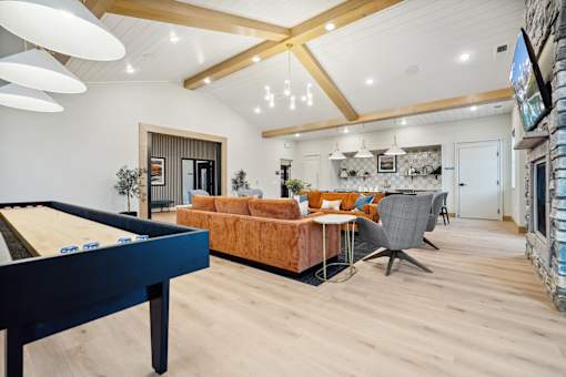 A living room with a pool table and a couch.