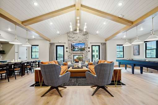A modern living room with a pool table and a television.