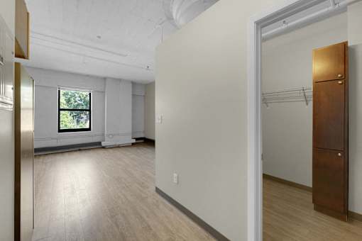 A room with a wooden floor and a window.