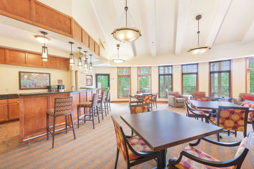 a dining room with a table and chairs and a kitchen