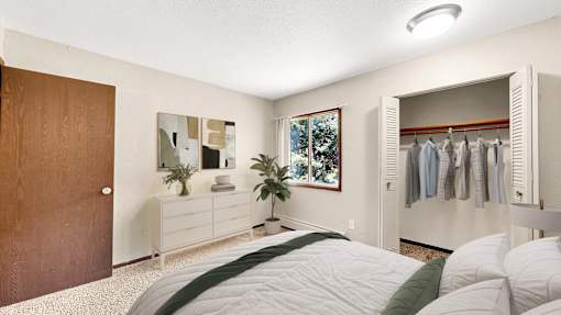 A bedroom with a bed, a dresser, and a wardrobe.