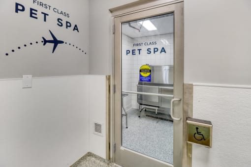 a glass door with a sign on the side of it that says first class pet spa