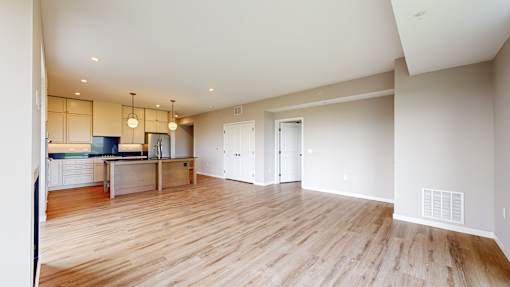 a living room and kitchen with wood flooring at Ardor on the Bluffs South Loop Residences Apartments, Minnesota, 55425