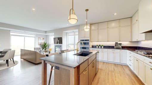 a large kitchen with an island and a living room at Ardor on the Bluffs South Loop Residences Apartments, Bloomington, MN, 55425