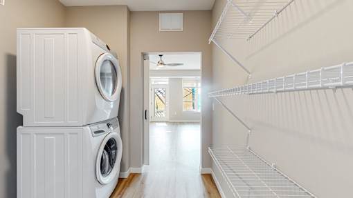 a laundry room with a washing machine and a closet at Ardor on the Bluffs South Loop Residences Apartments, Bloomington, MN