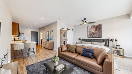 a living room with a couch and a bed at Ardor on the Bluffs South Loop Residences Apartments, Bloomington, MN