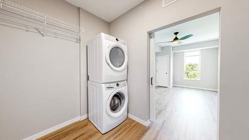 a white washer and dryer in a room with a door to a closet at Ardor on the Bluffs South Loop Residences Apartments, Bloomington, 55425