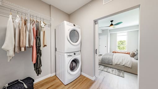 a washer and dryer in a closet in a bedroom at Ardor on the Bluffs South Loop Residences Apartments, Bloomington, Minnesota