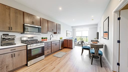 a large kitchen with wooden cabinets and stainless steel appliances at Ardor on the Bluffs South Loop Residences Apartments, Minnesota