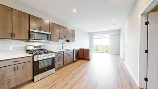 A kitchen with wooden cabinets and a stove top oven.