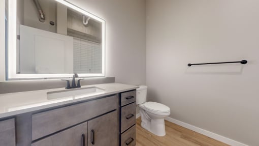 an empty bathroom with a toilet and a sink at Ardor on the Bluffs South Loop Residences Apartments, Bloomington