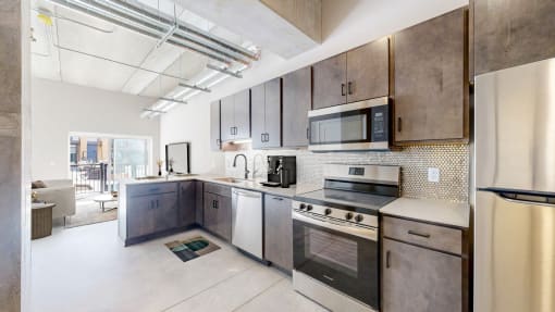 kitchen with tile backsplash, breakfast counter backed up to a living room area at Ardor on the Bluffs South Loop Residences Apartments, Minnesota