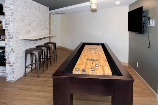 Shuffleboard table and tv at Aspenwoods Apartments, Eagan