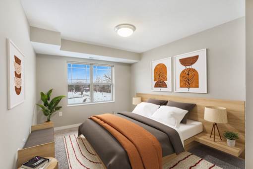 A bedroom with a large bed and a window showing a snowy landscape outside.