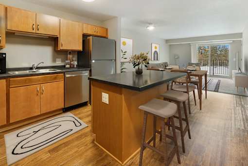 A kitchen with wooden cabinets and a black countertop.