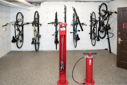 a bike storage room with bikes and a red fix-it station