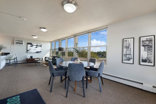 a conference room with a table and chairs and large windows