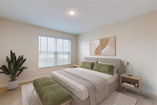 A bedroom with a large bed, a green bench, and a potted plant.