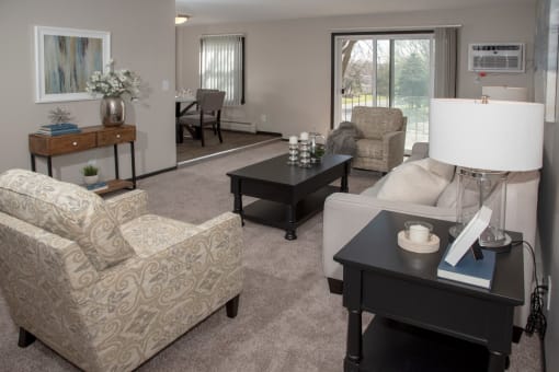 one plus den model, living room with view of balcony and dining area