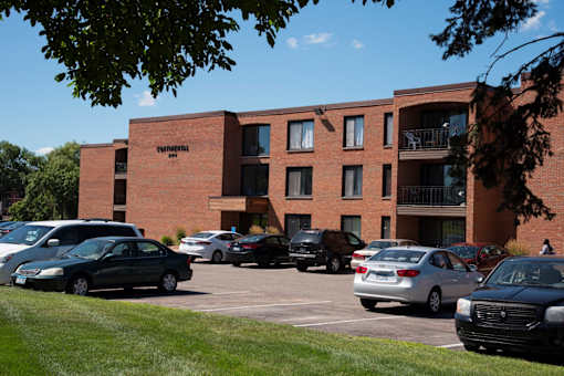 A parking lot with cars and a building with the word