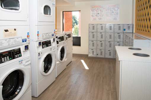A laundry room with washing machines and a dryer.