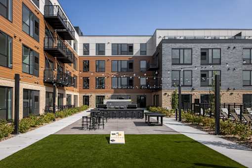 A modern building with a grassy area in front.
