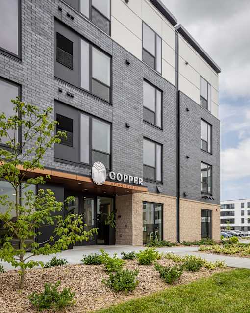 A modern building with the word "COOPER" on the entrance.
