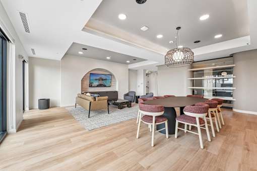 A modern dining room with a round table and chairs.
