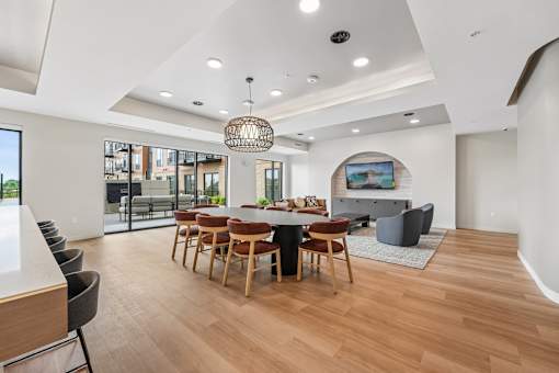 A modern dining room with a wooden table and chairs.